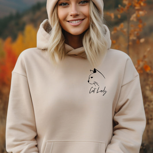 A woman wearing a Cat Lover hoodie for ladies with an image of a cat and caption that says Cat Lady, this cute hoodie is a great gift idea for cat owners. 